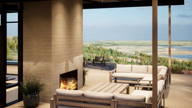 A living room with a fireplace and a view of the ocean.