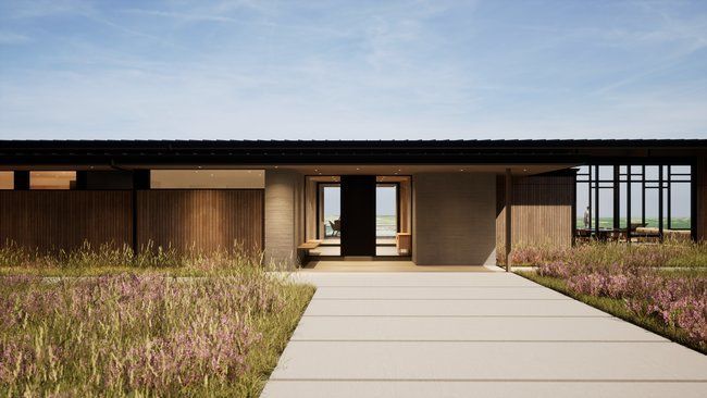 modern house with a concrete walkway leading to it.