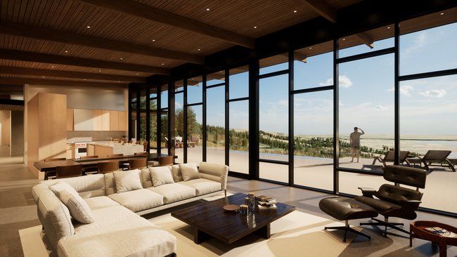 A living room with a couch, coffee table, chair, and lots of windows.