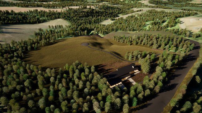 view of a house in the middle of a forest surrounded by trees.