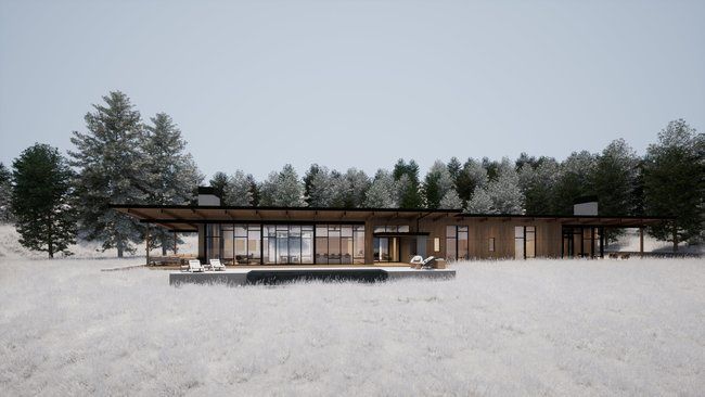 house sitting in the middle of a snowy field surrounded by trees.