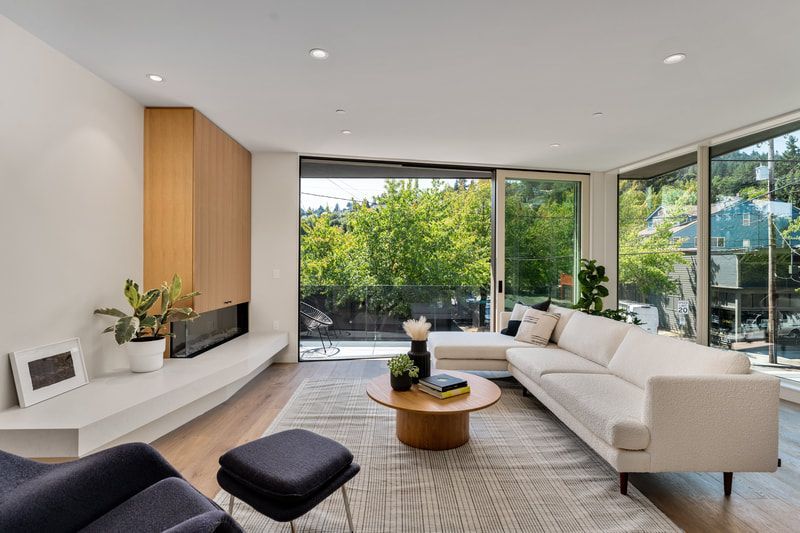 A living room with a couch, chair, a coffee table, and a fireplace.