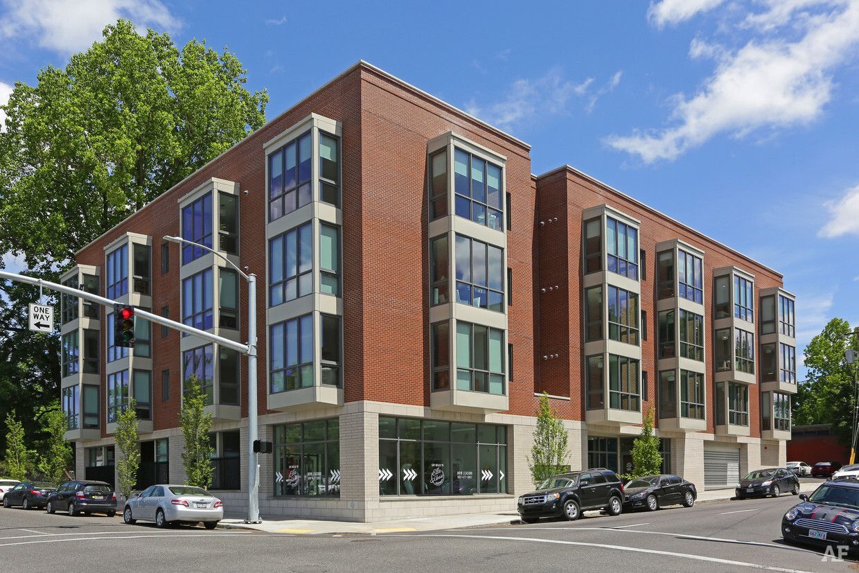 A large brick building with cars parked in front of it