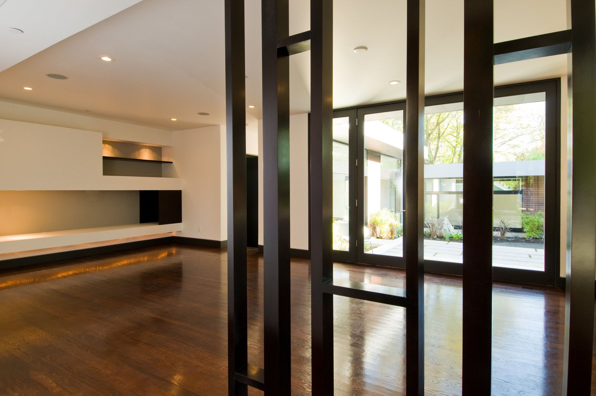 A room with a lot of windows and a wooden floor