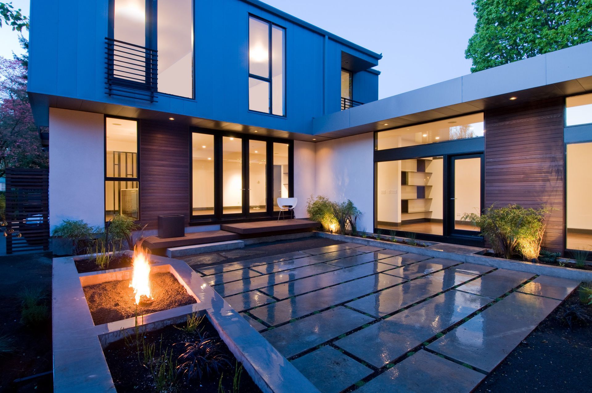 A blue house with a fire pit in front of it