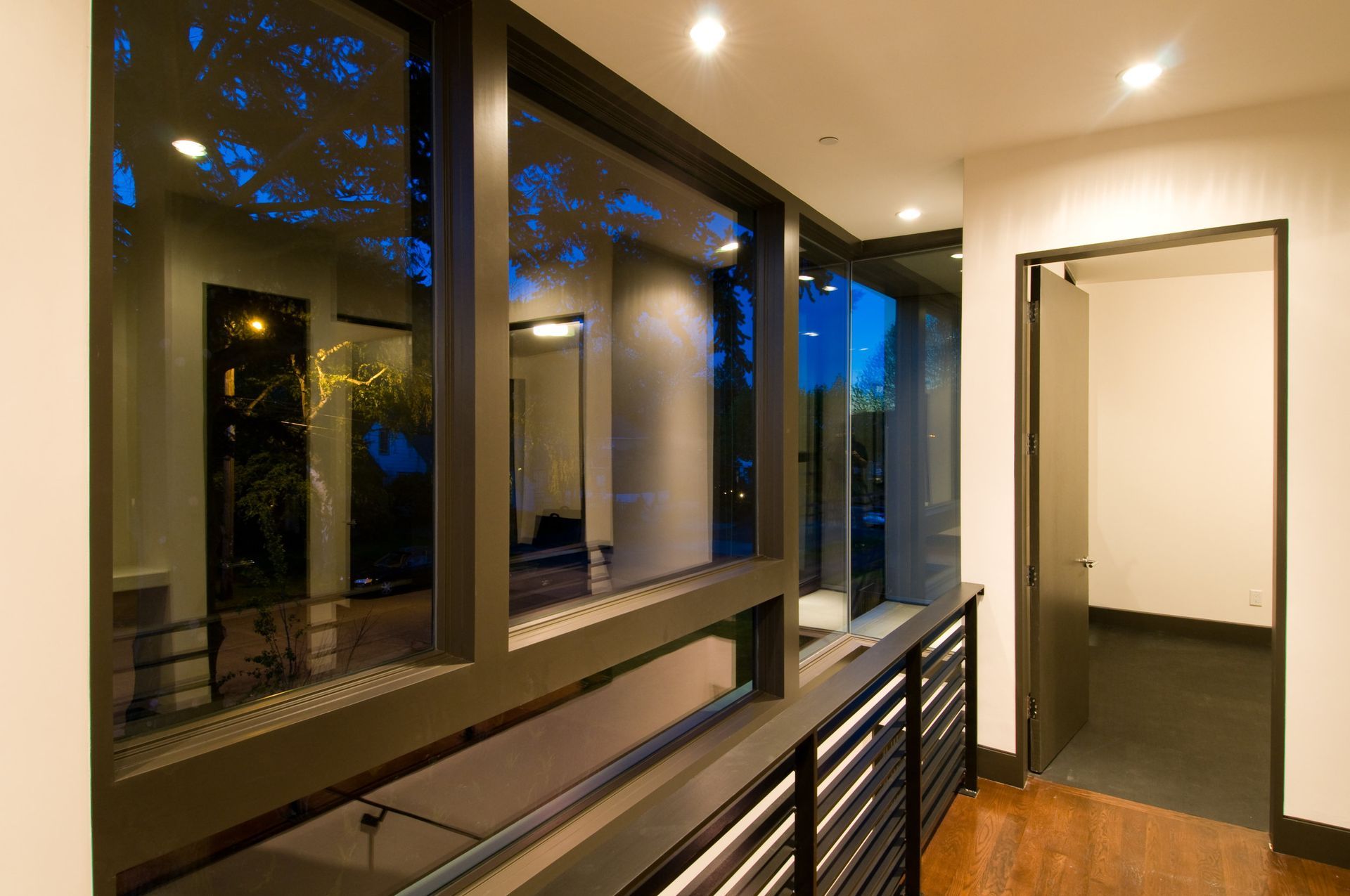 A hallway with a lot of windows and a door