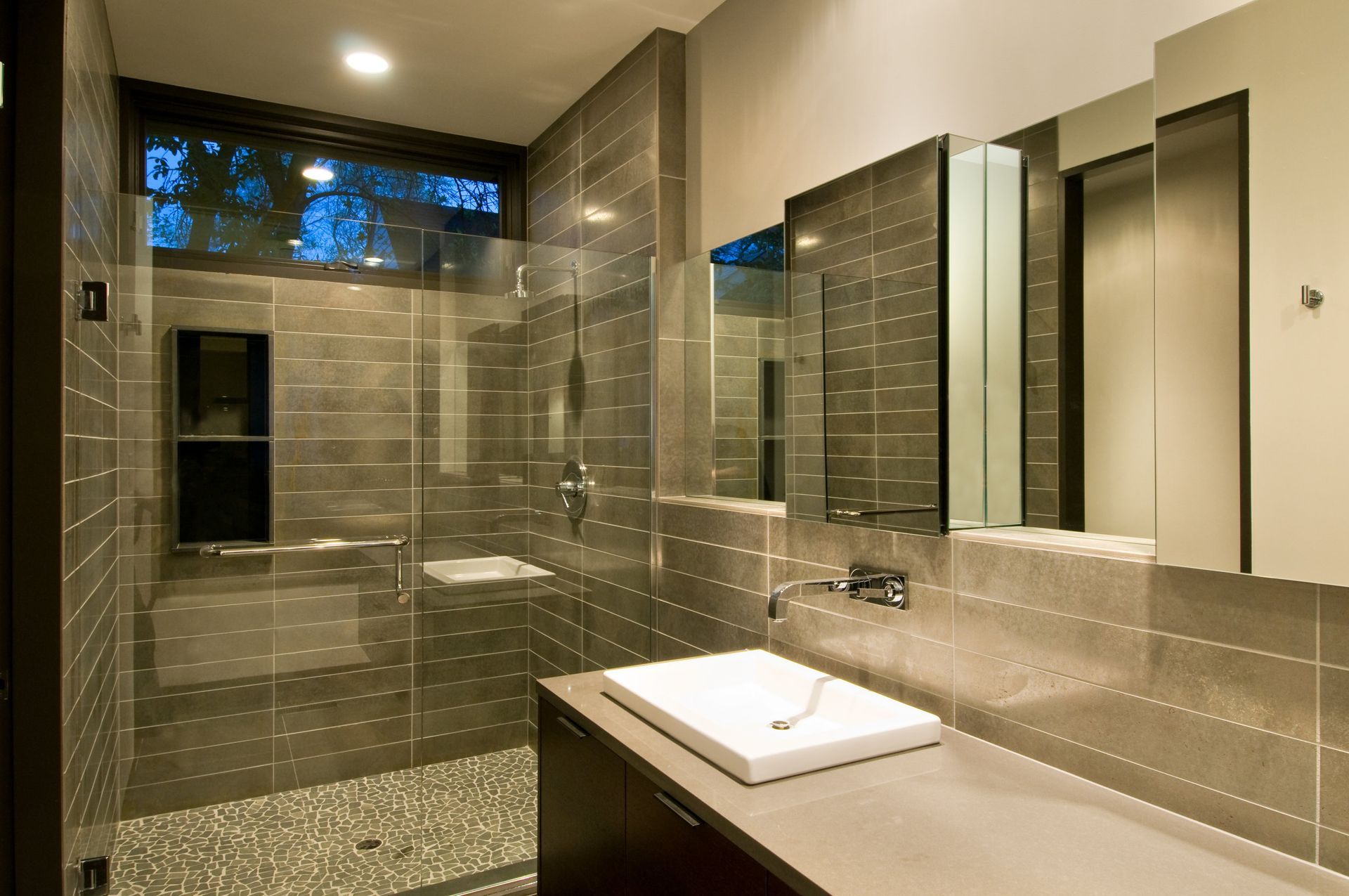 A bathroom with a sink and a walk in shower