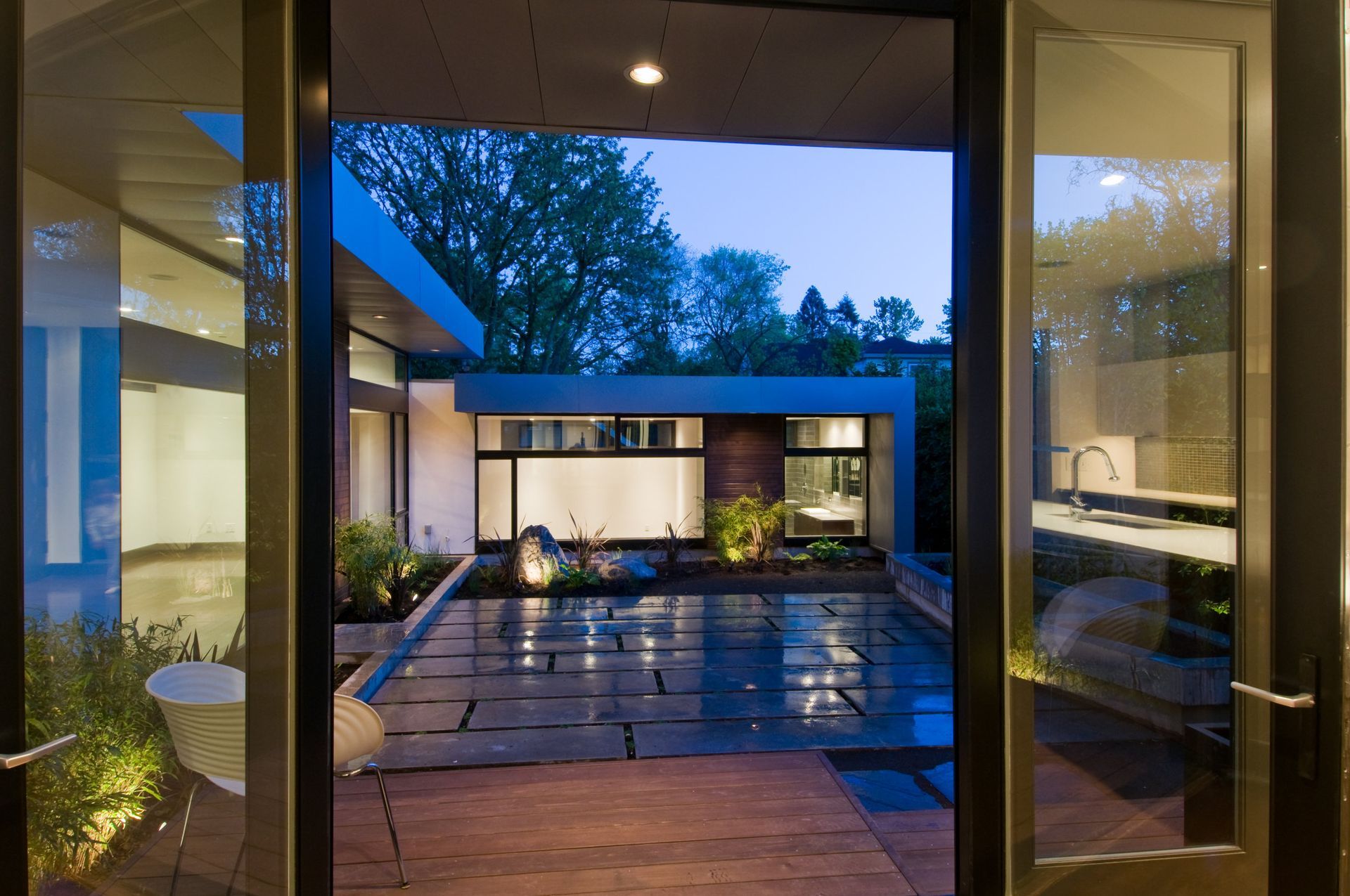 A view of a house through a glass door at night