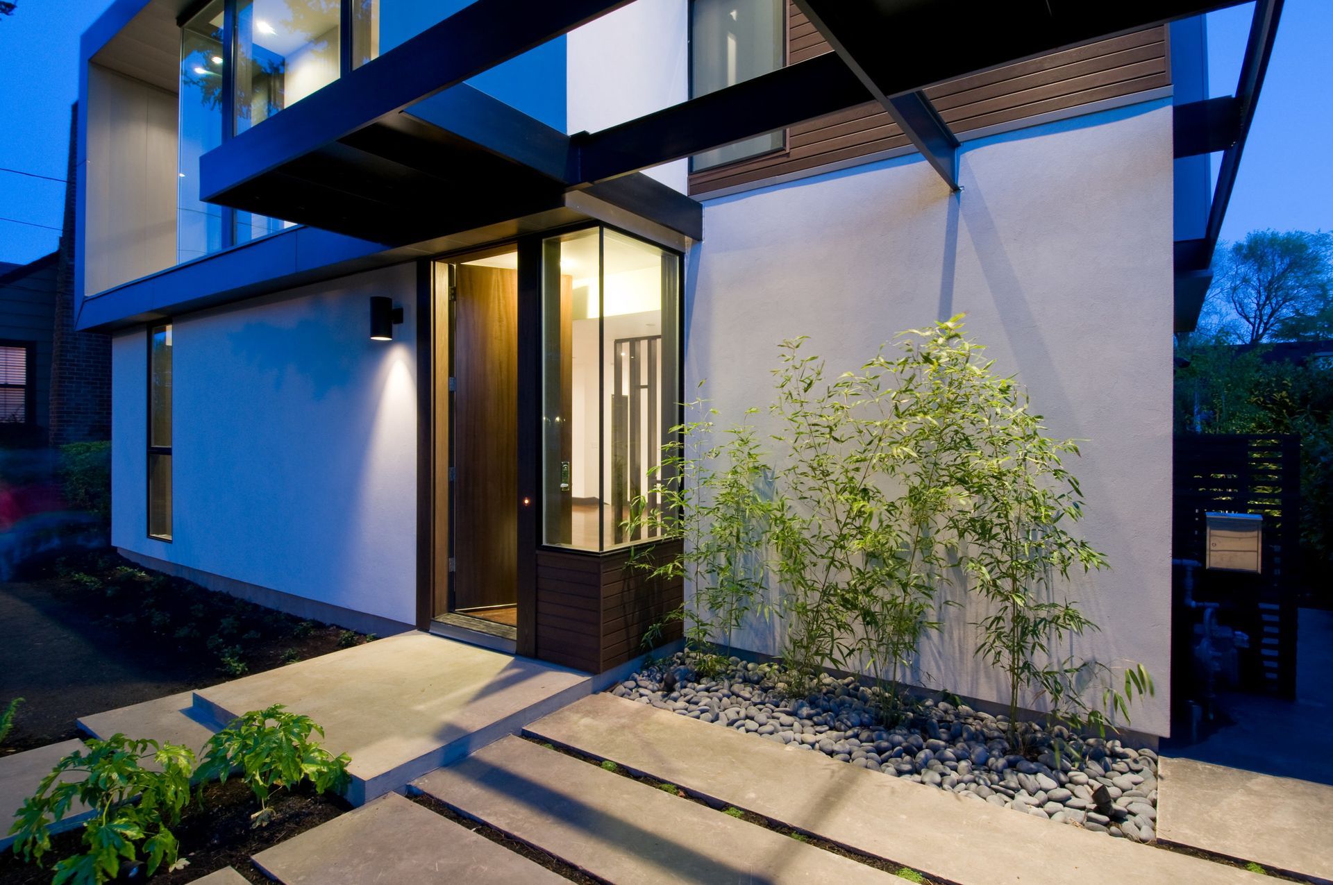 A modern house with a walkway leading to the front door
