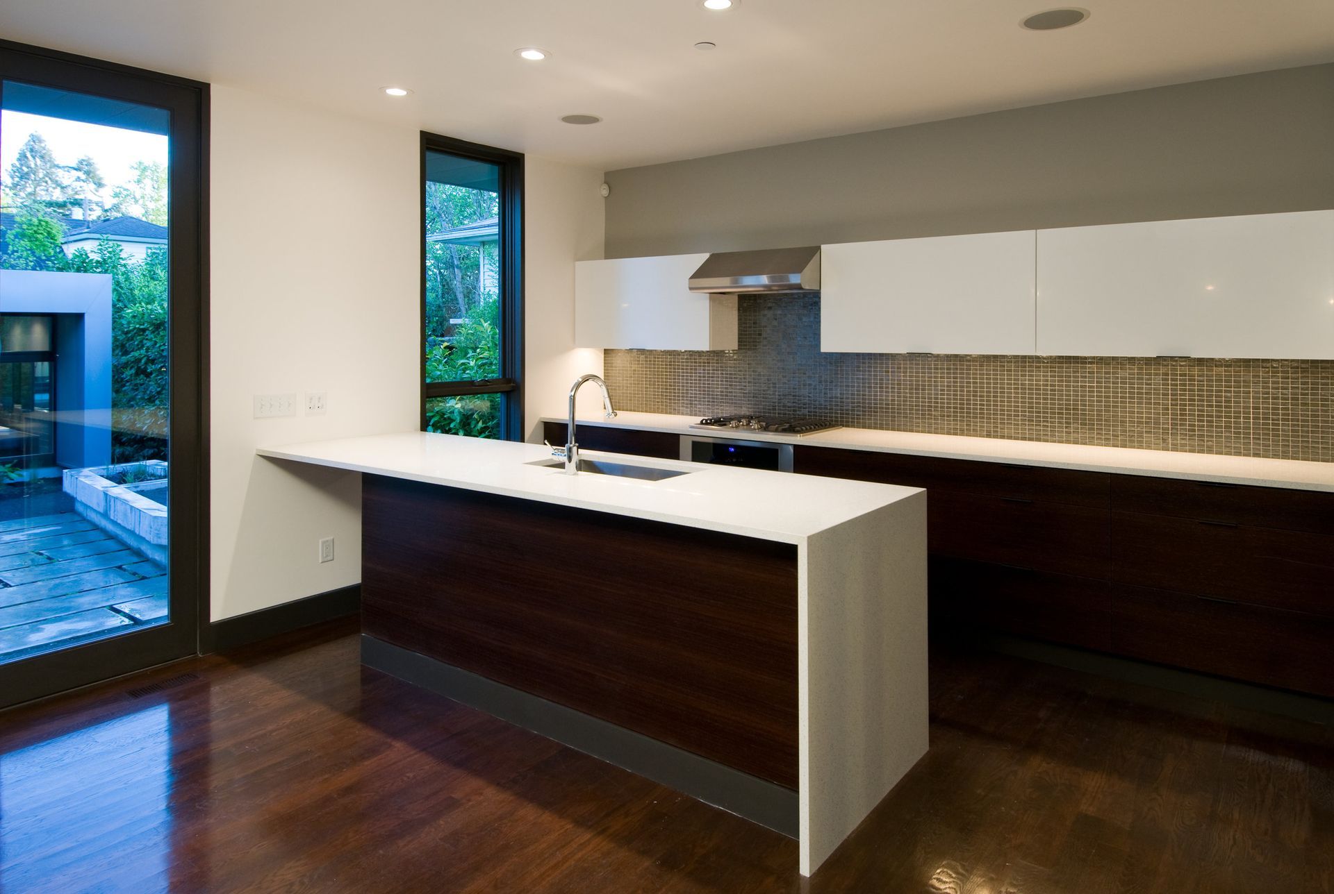 An empty kitchen with a large island in the middle