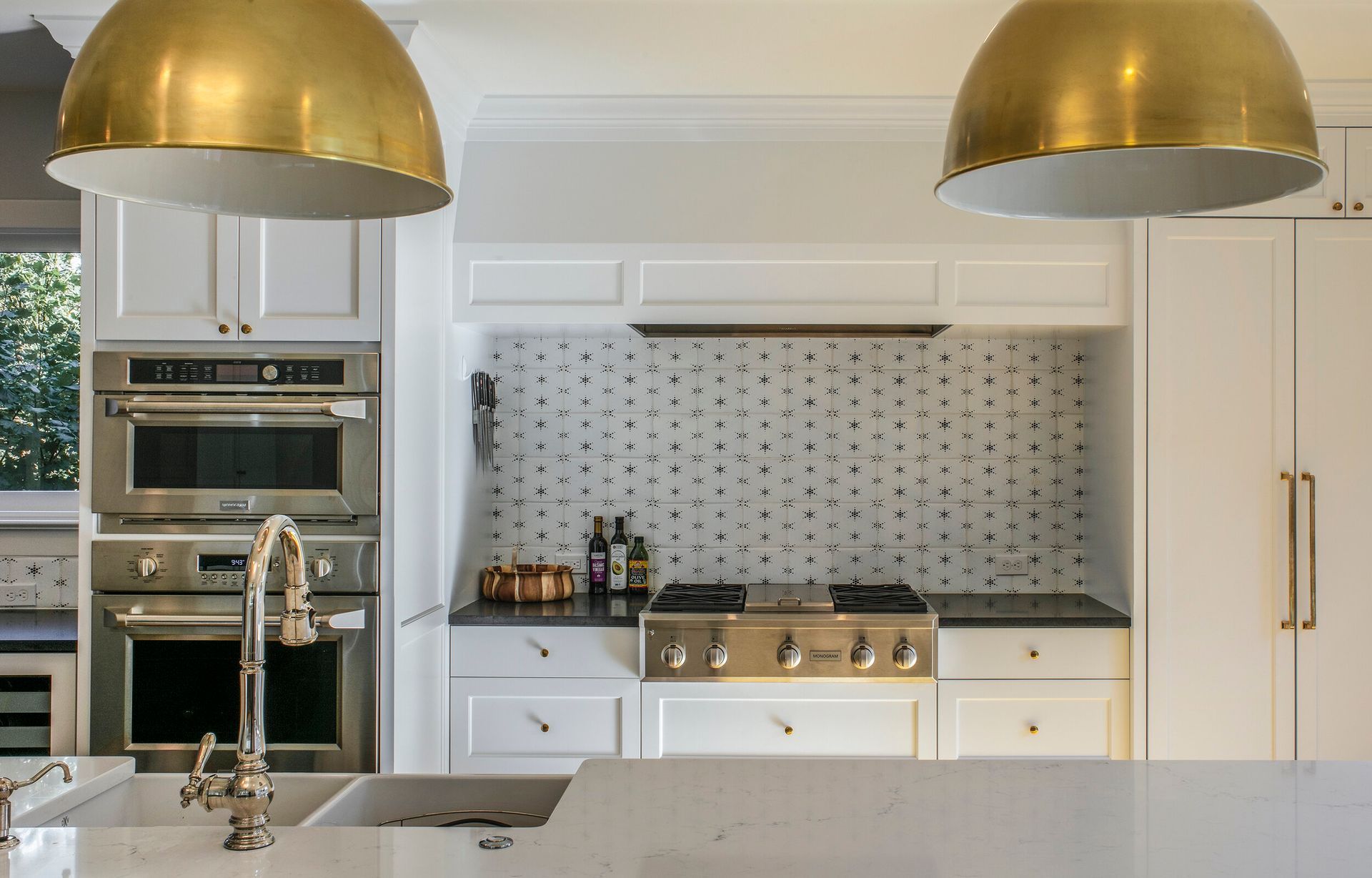 A kitchen with stainless steel appliances and white cabinets