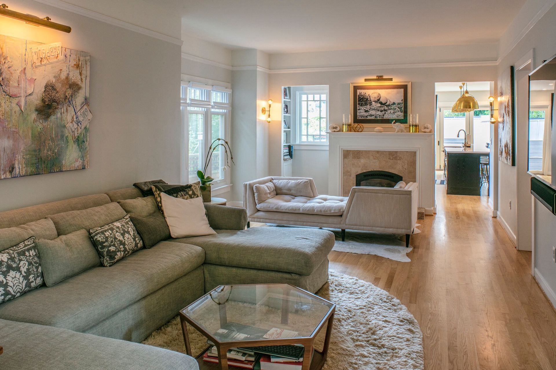 A living room with a couch , chair , coffee table and fireplace.