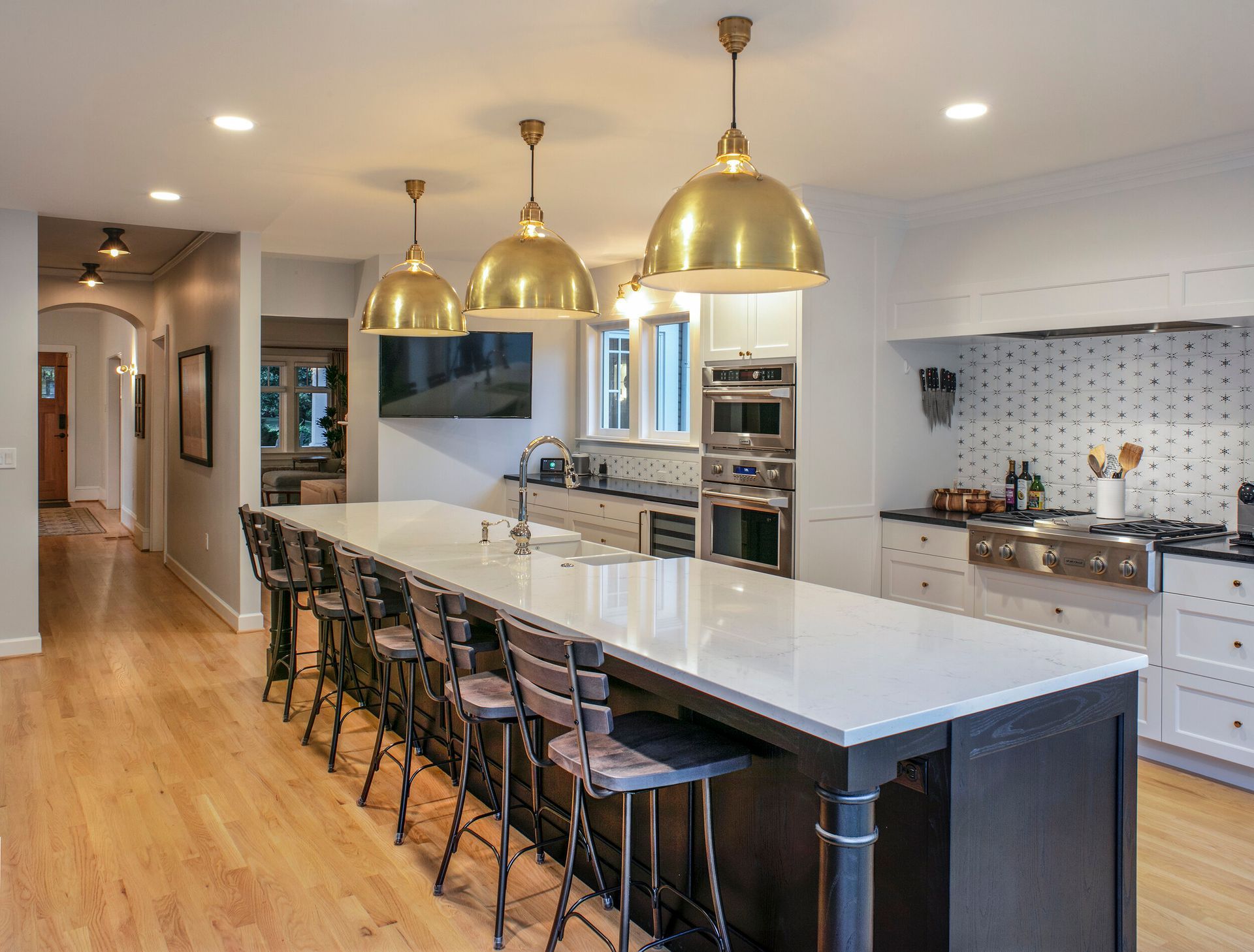 A large kitchen with a large island and stools.