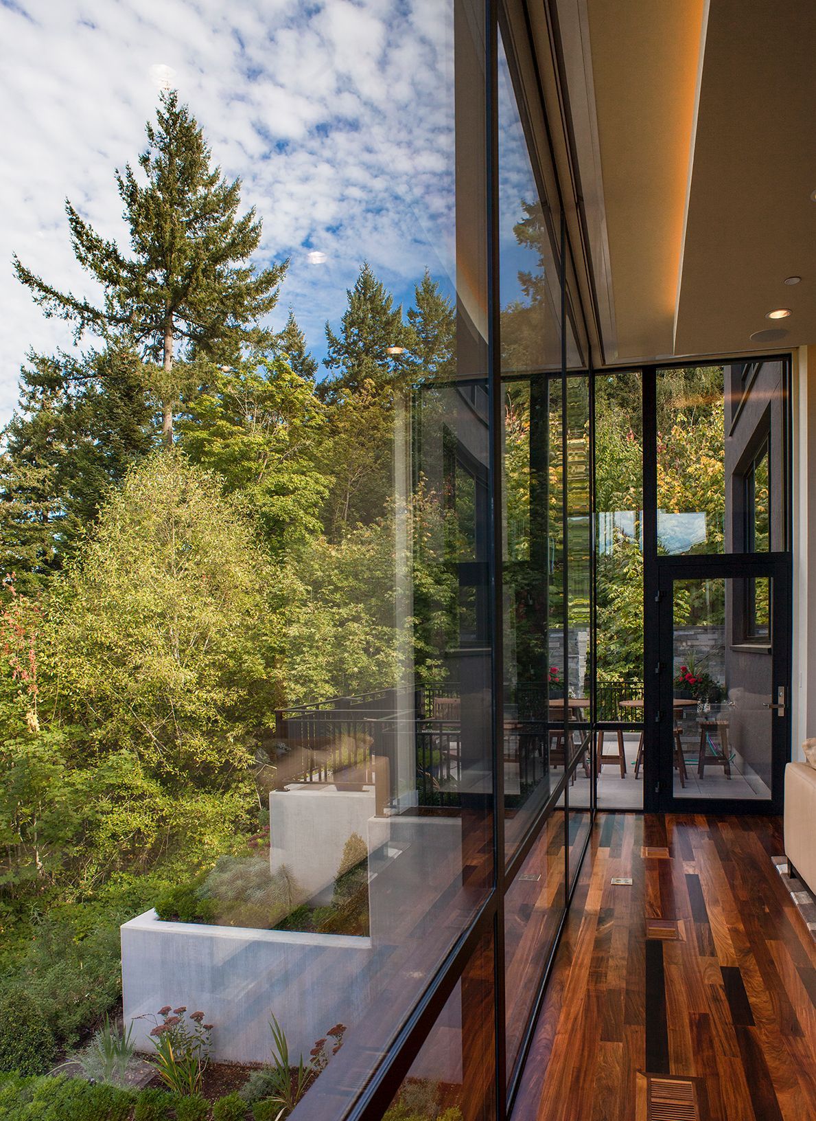 A room with a lot of windows and trees in the background