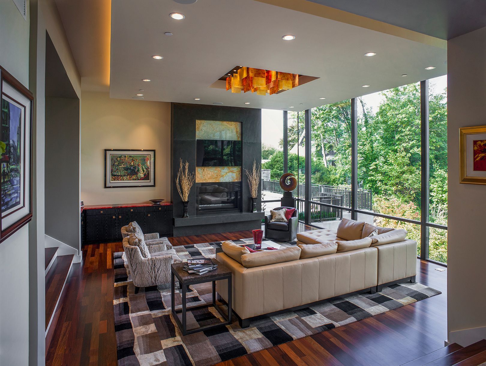 A living room with a couch , chairs , and a fireplace.