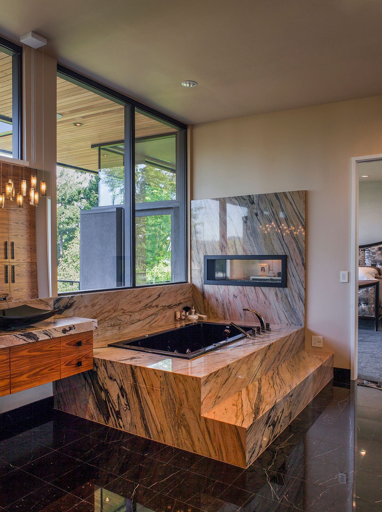 A bathroom with a large tub and a fireplace