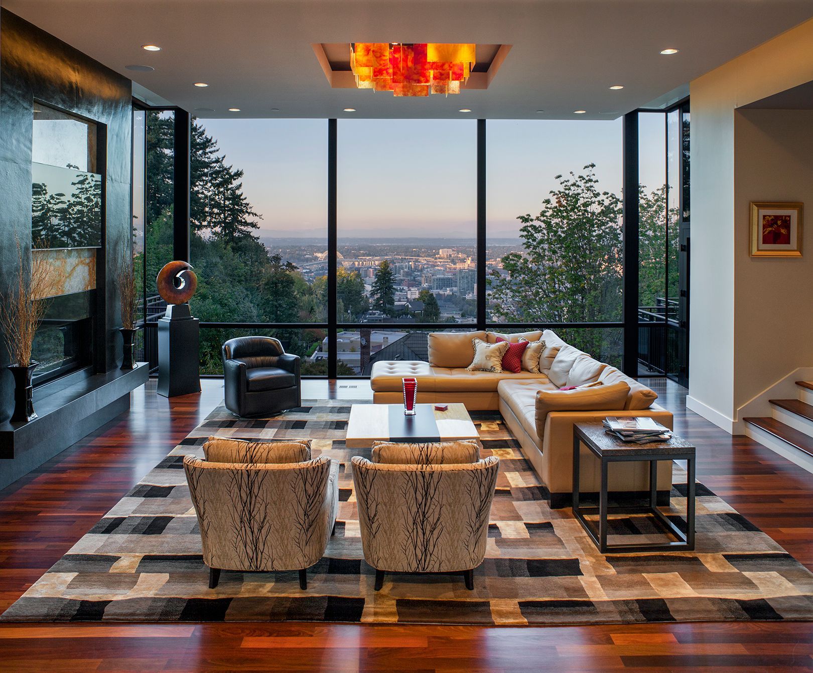 A living room with a large sectional couch and chairs