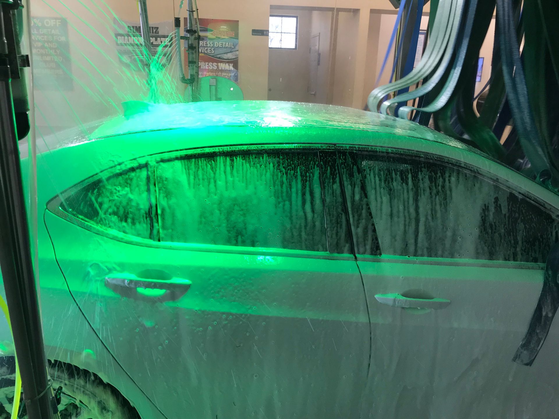 car wash very soappy white car pass side