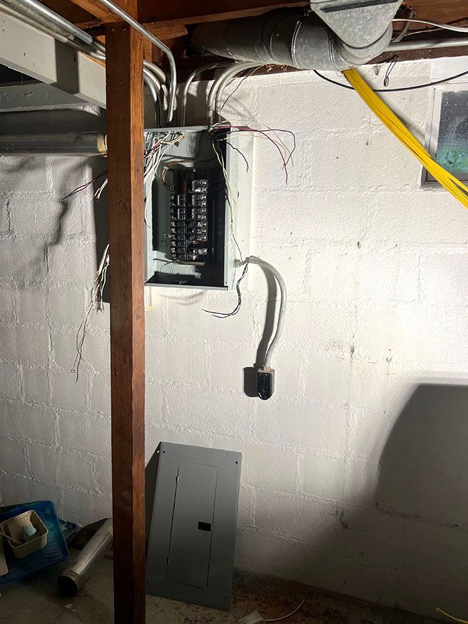 An electrical box on the wall in the basement