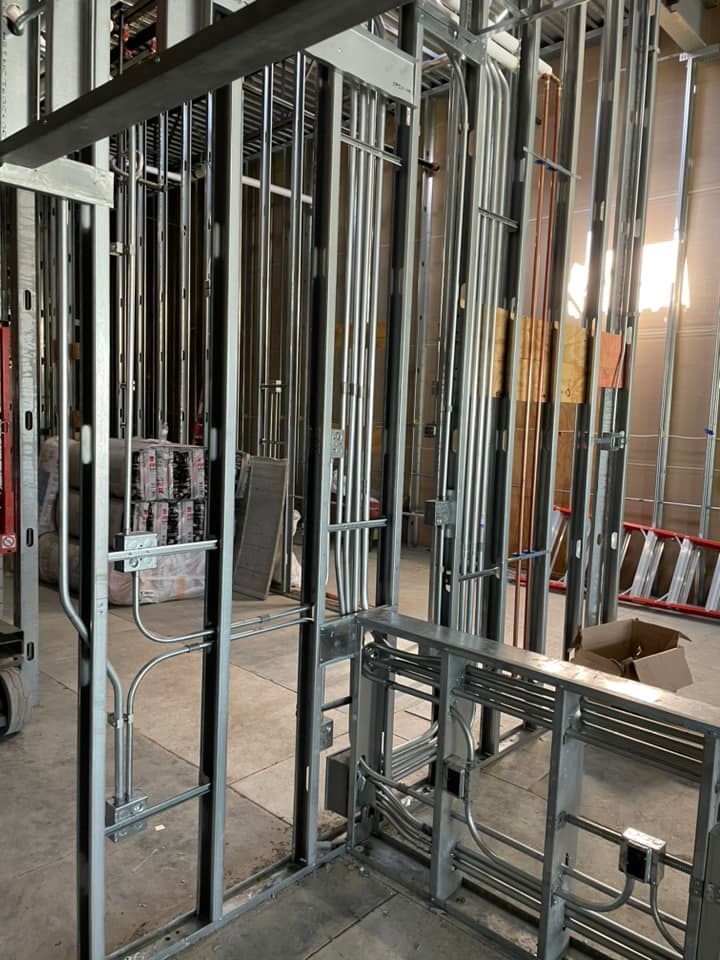 A building under construction with a lot of metal frames and wires