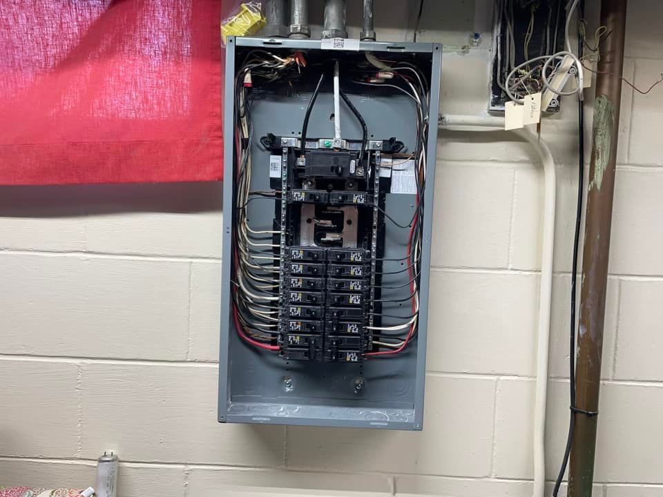An electrical box is installed on a white brick wall