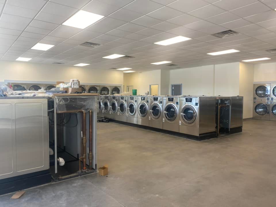 A laundromat with a lot of washers and dryers in it