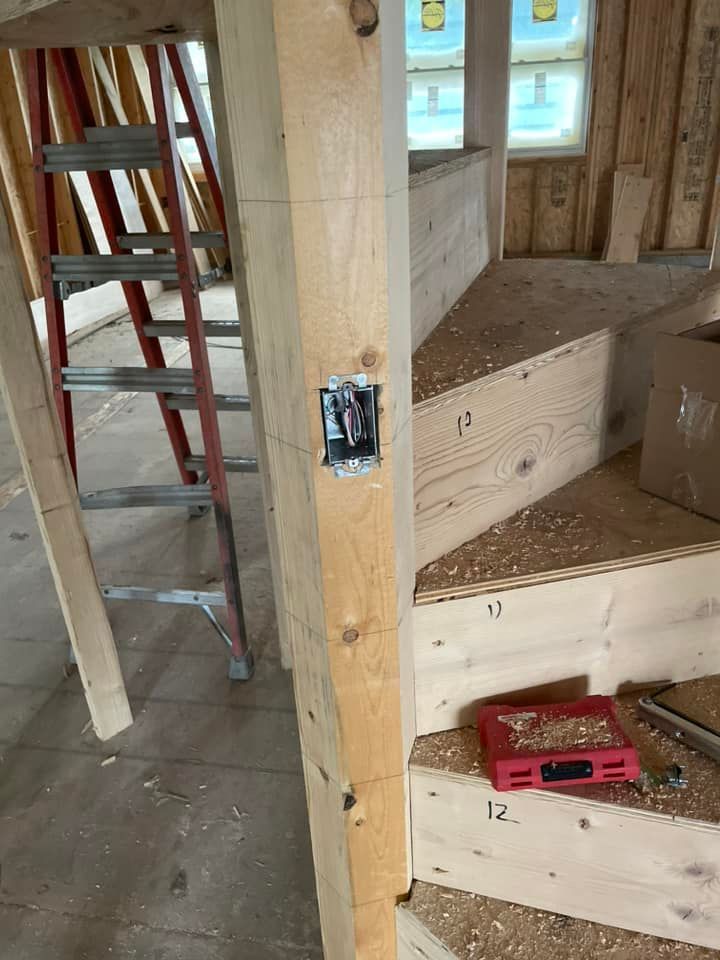 Electrical wiring has been installed along a wooden staircase