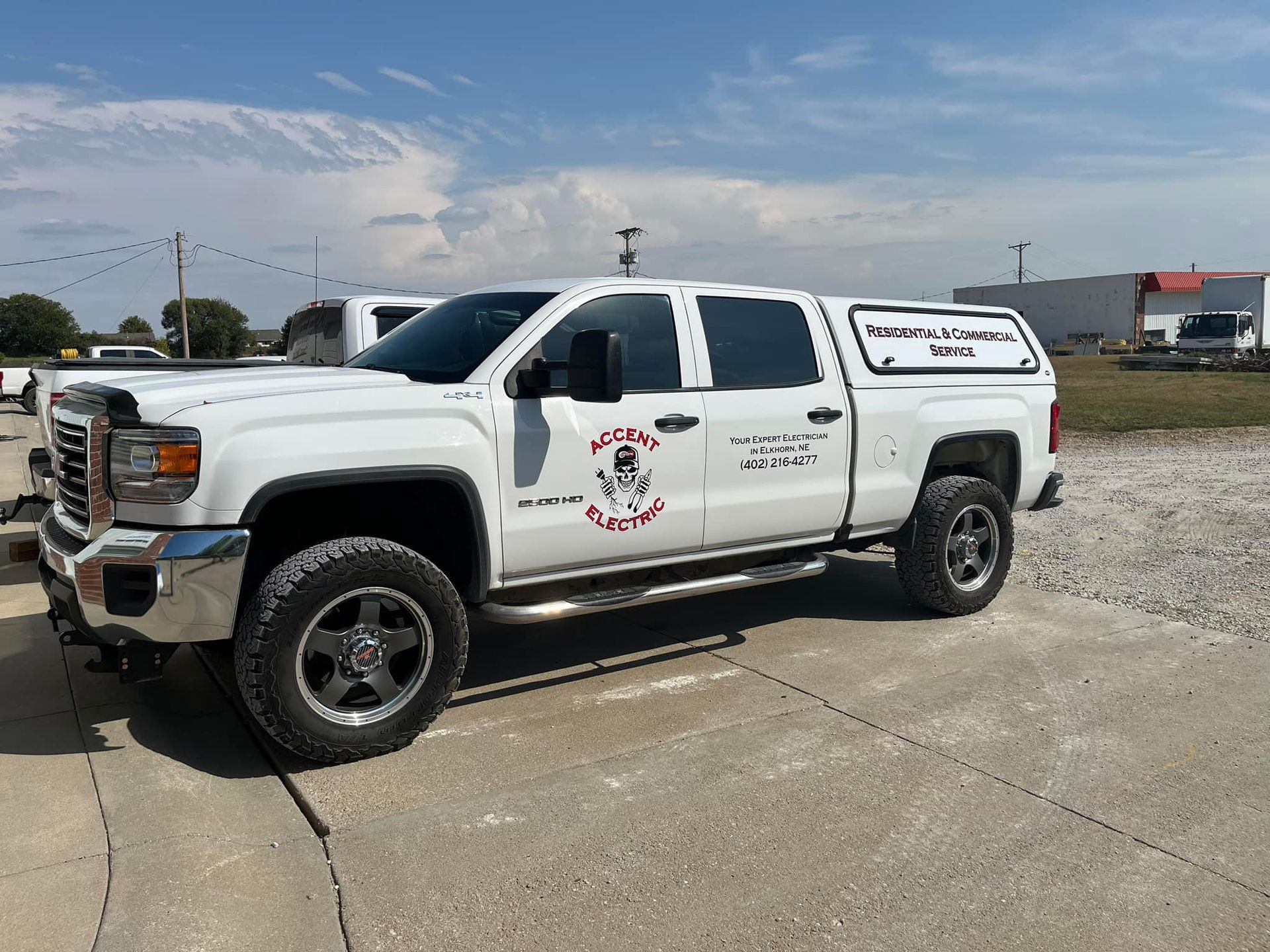 A white truck is parked on the side of the road