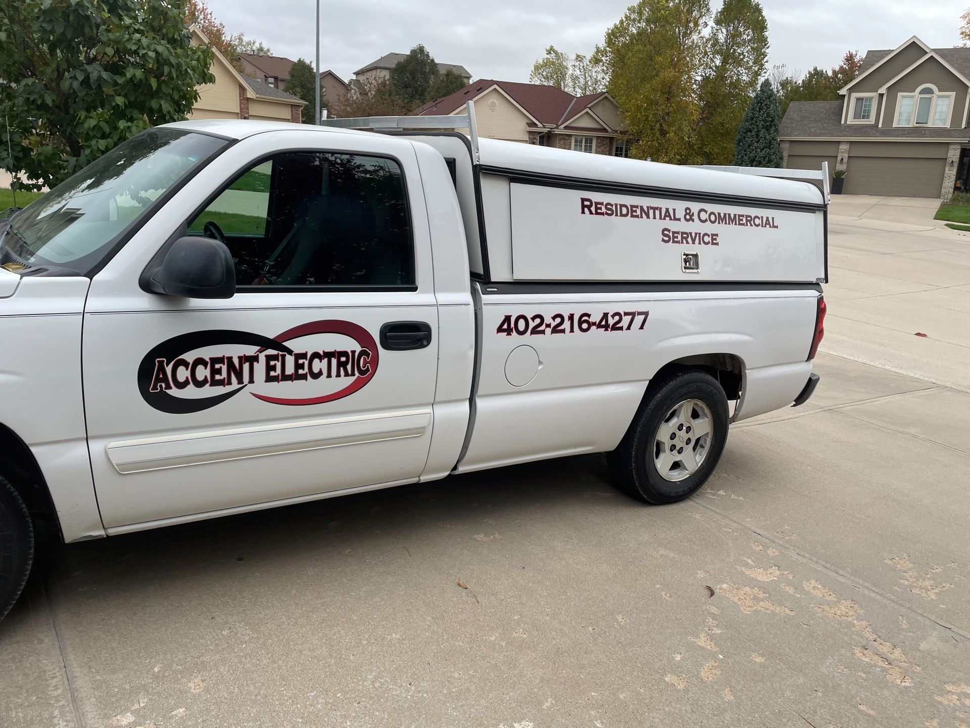 A white truck is parked in a driveway