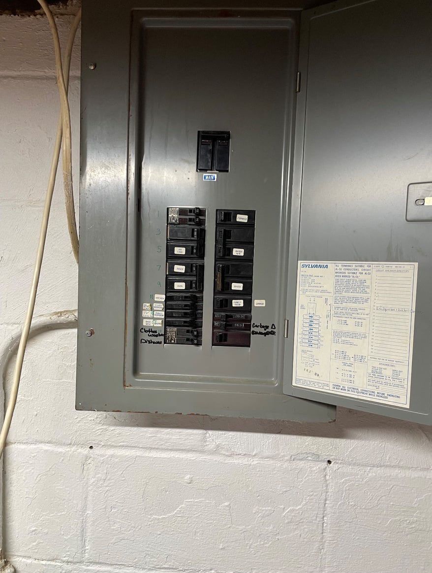 A close up of a electrical box on a brick wall