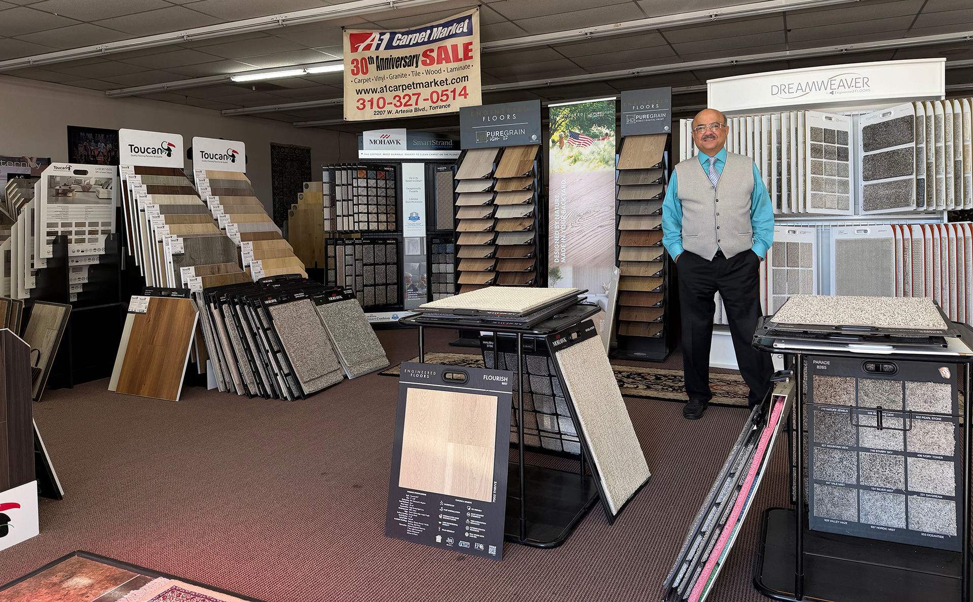 Tile and flooring showroom with displays of samples and a person standing inside