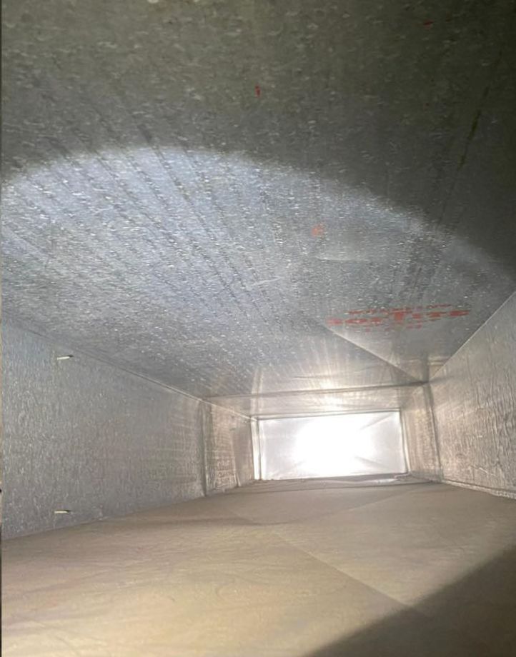 Looking down into a duct with a light shining through it.