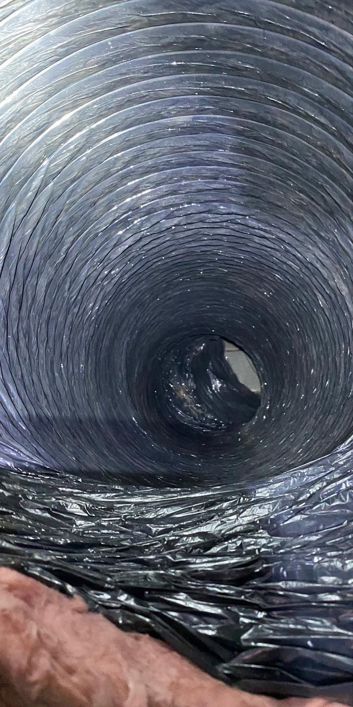 A close up of a person holding a duct with a hole in it.