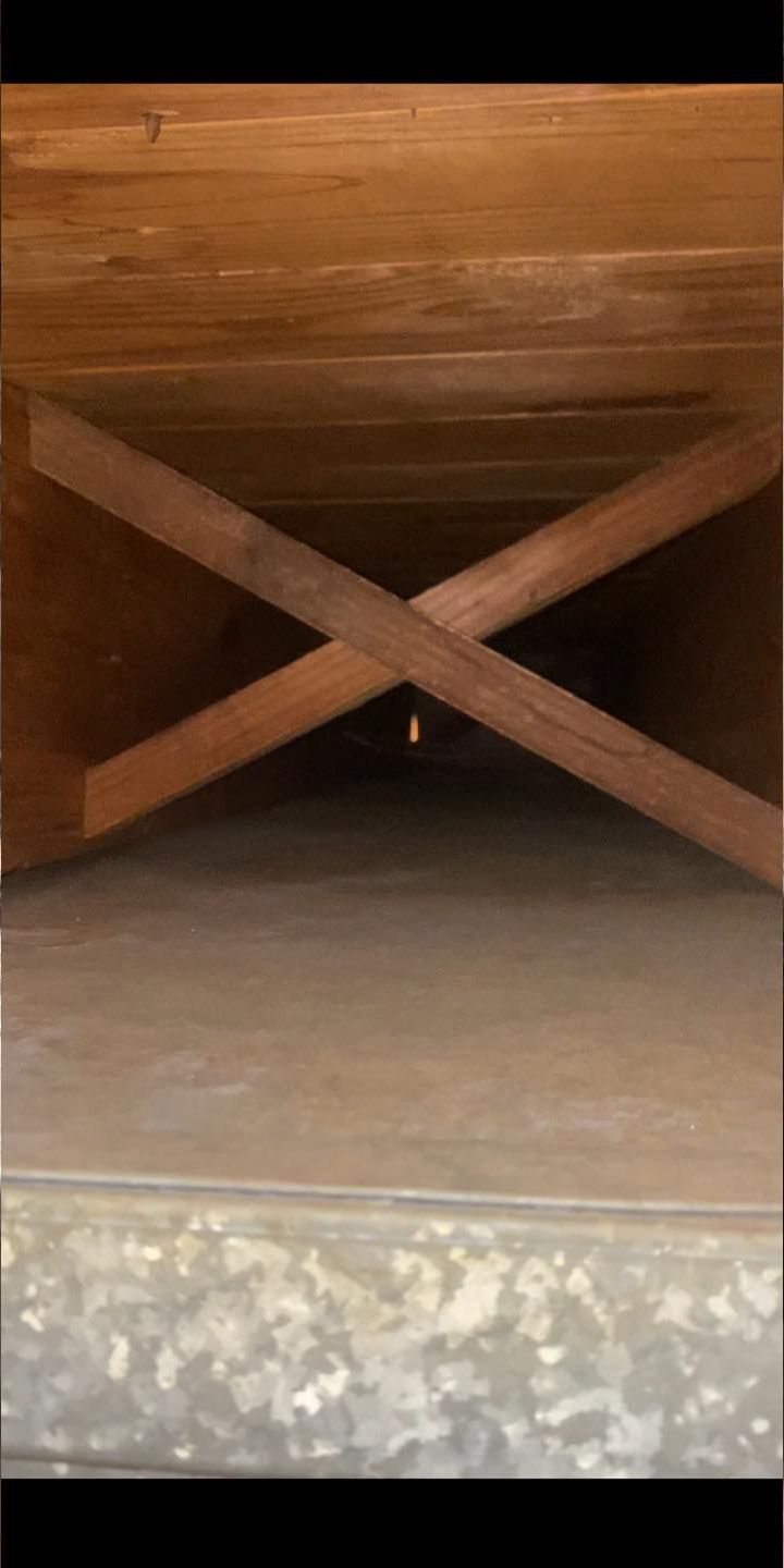 A wooden table is sitting on top of a concrete floor.