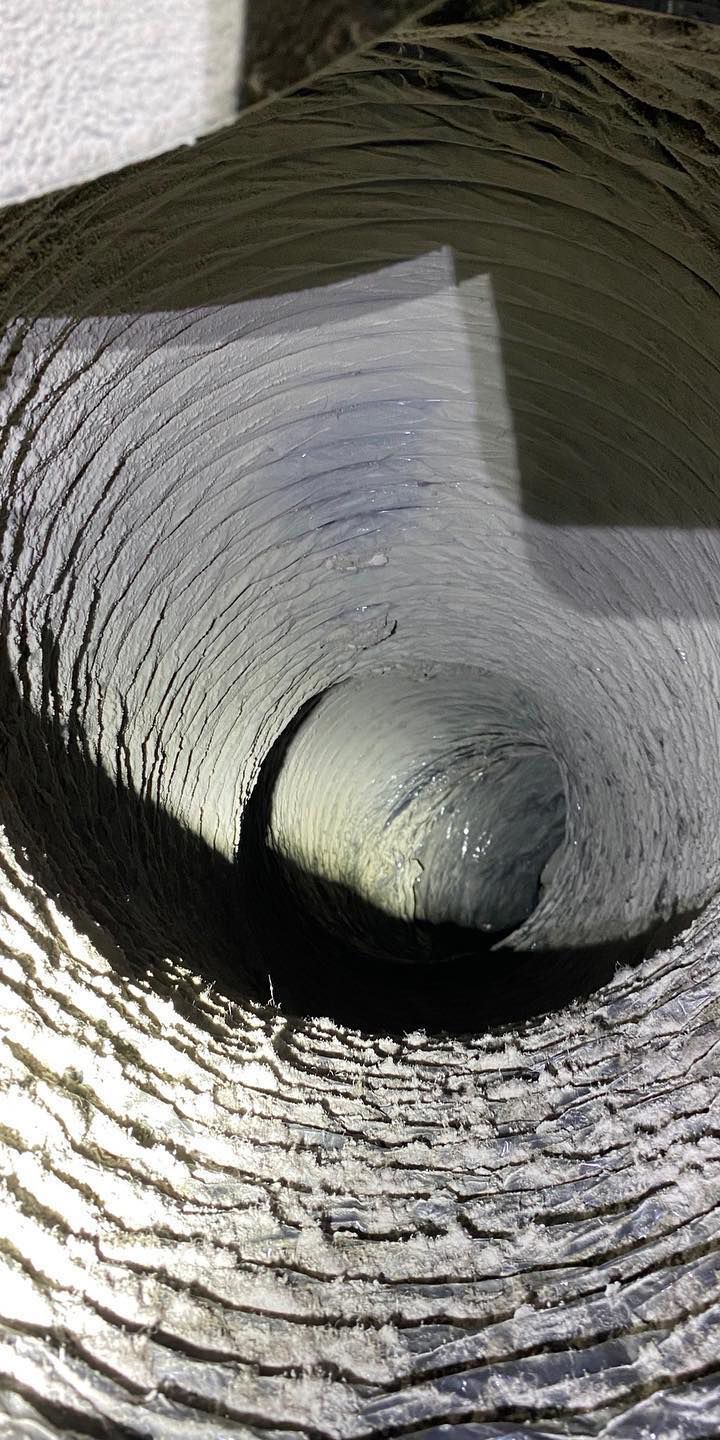 A close up of a metal pipe with a hole in it.