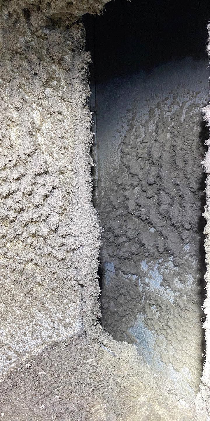 A close up of a dirty carpet with a hole in it.