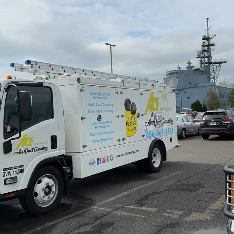 An air duct cleaning truck is parked in a parking lot