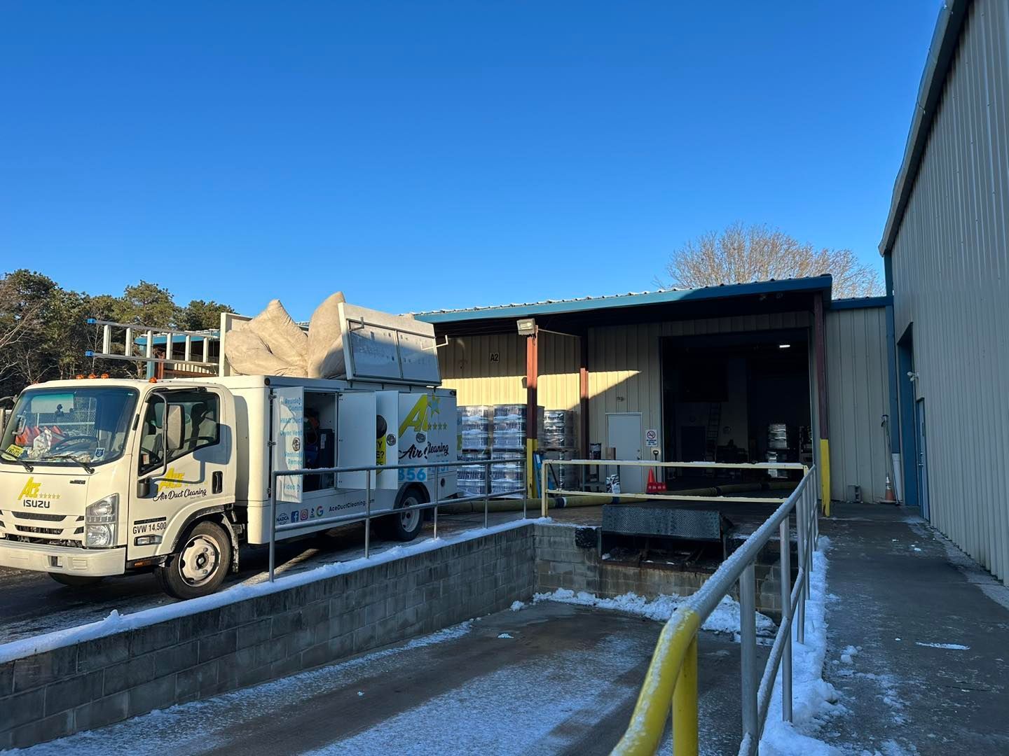 A white truck is parked in front of a building.