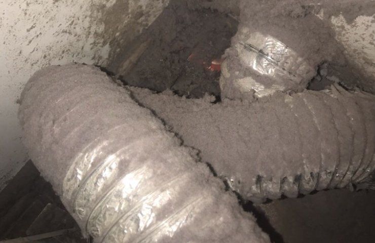 A close up of a dirty duct in a room.