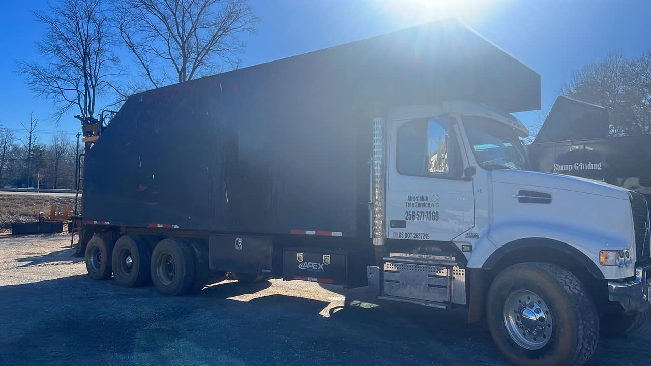 a white truck with a black tarp on top of it is parked in a parking lot