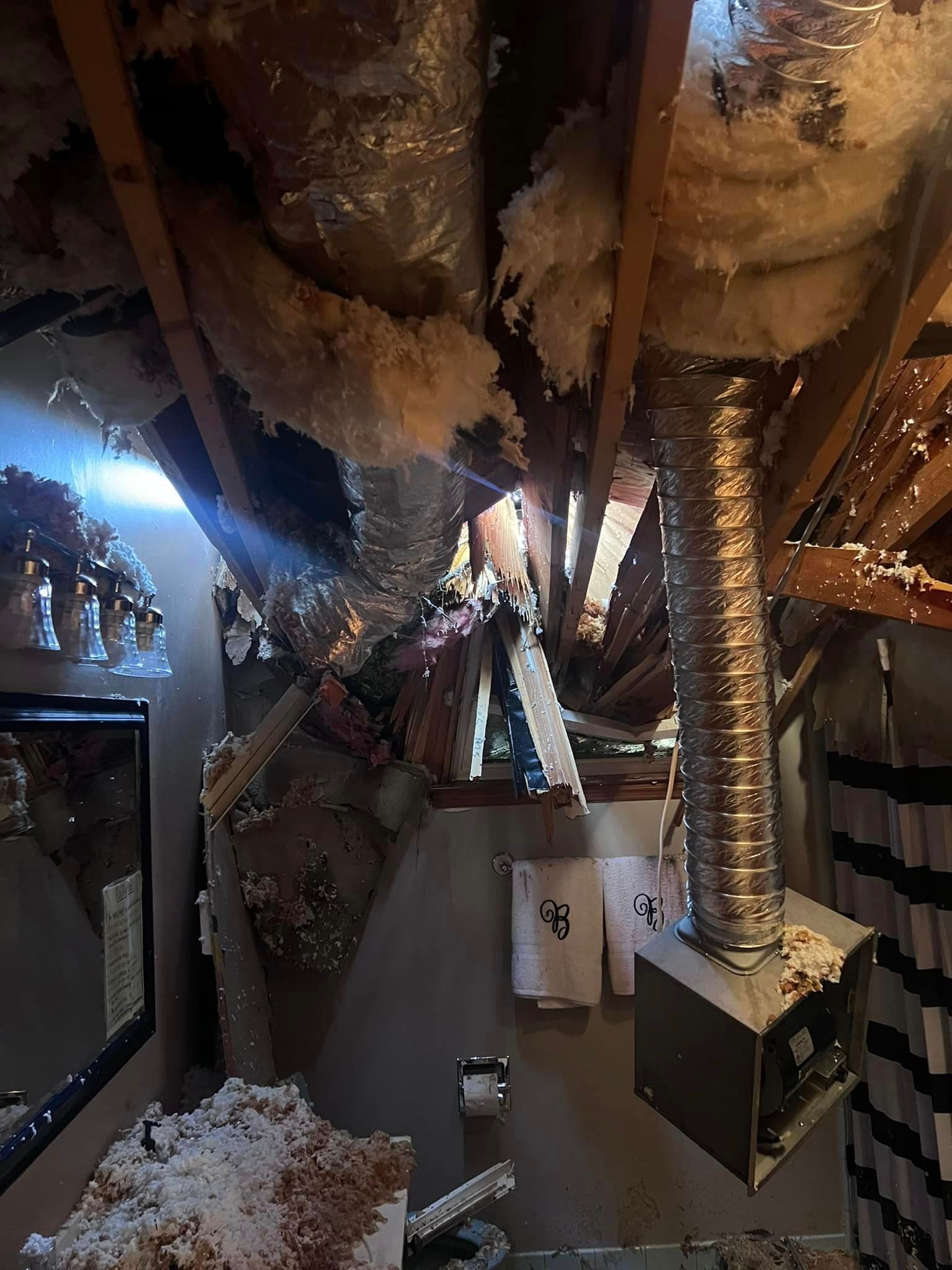 a bathroom with a lot of ducts hanging from the ceiling