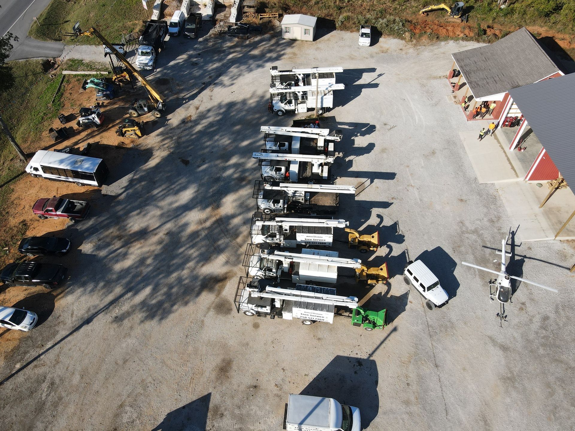 an aerial view of a row of trucks parked in a parking lot