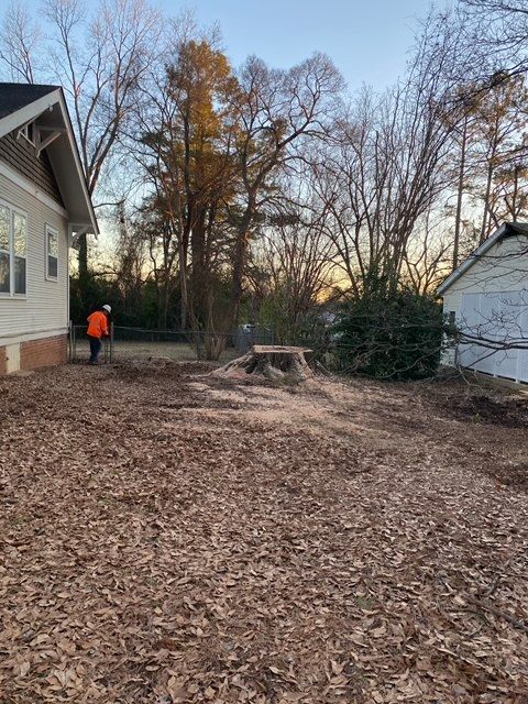 a man is standing in the dirt in front of a house