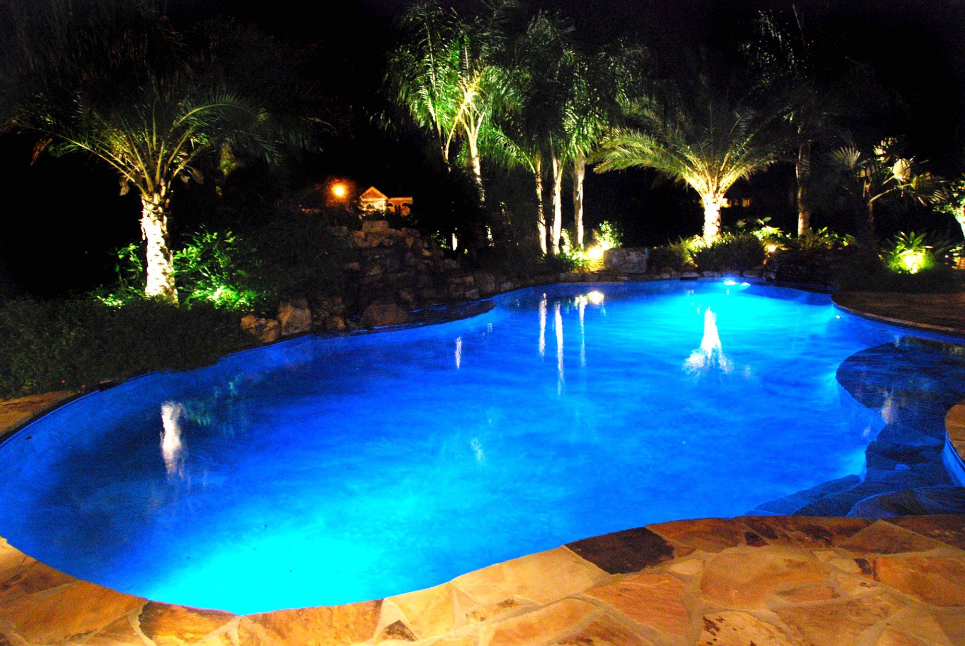 Swimming pool with blue lighting at night