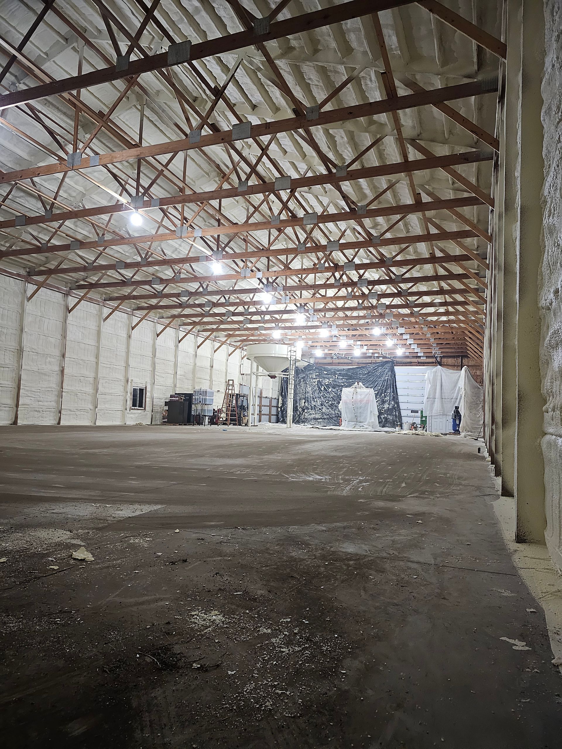 A large empty warehouse with a lot of foam on the walls and ceiling.