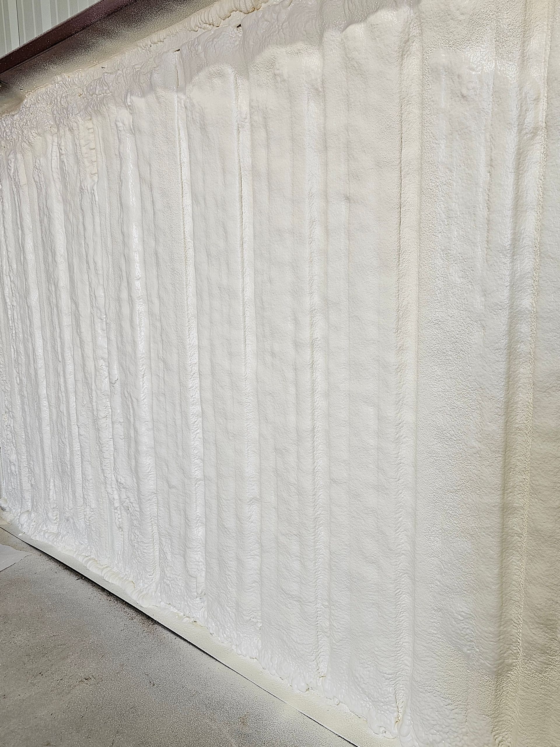 A close up of a white wall with a lot of foam on it.