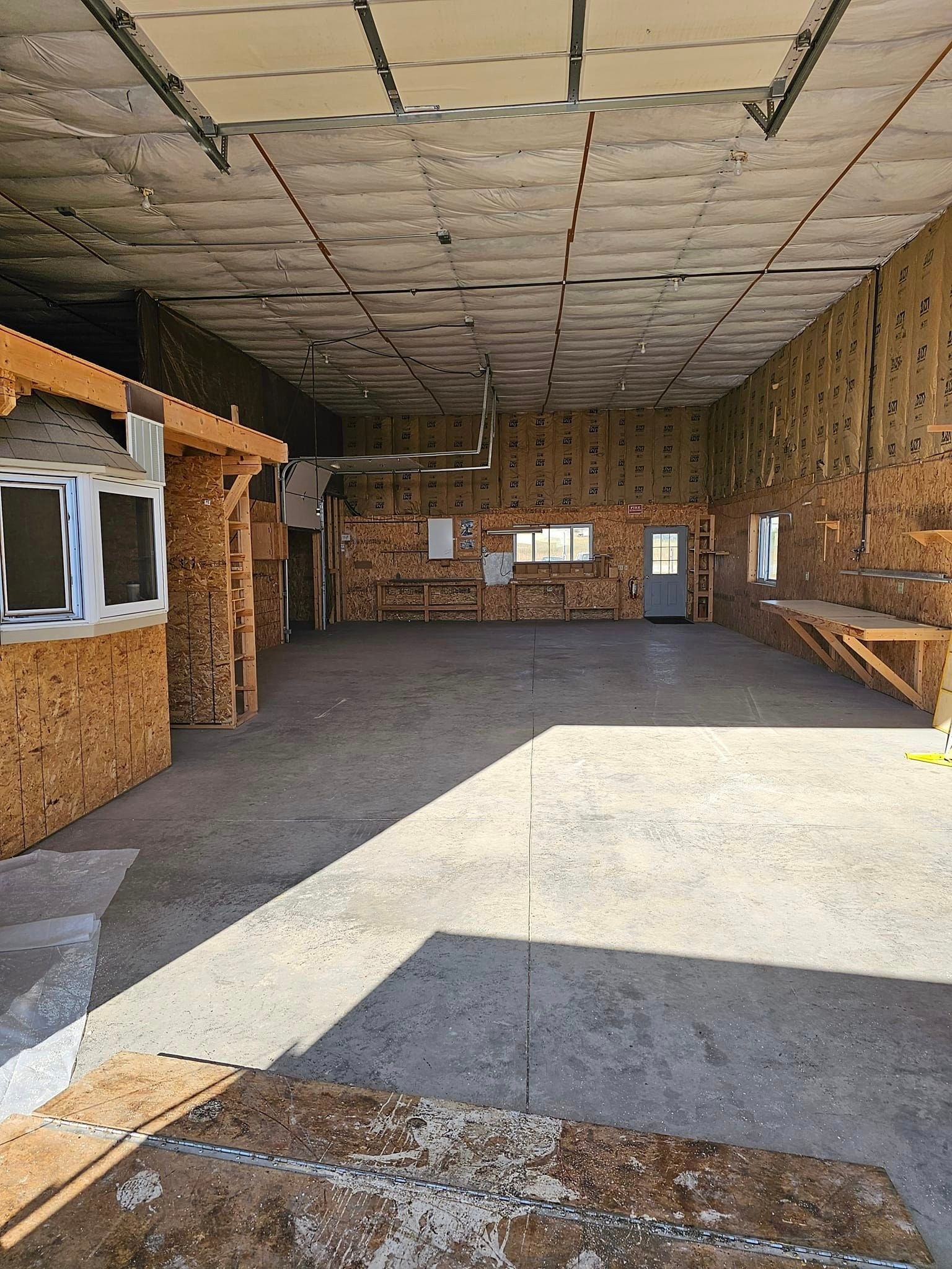 A large empty room with wooden walls and a ceiling.