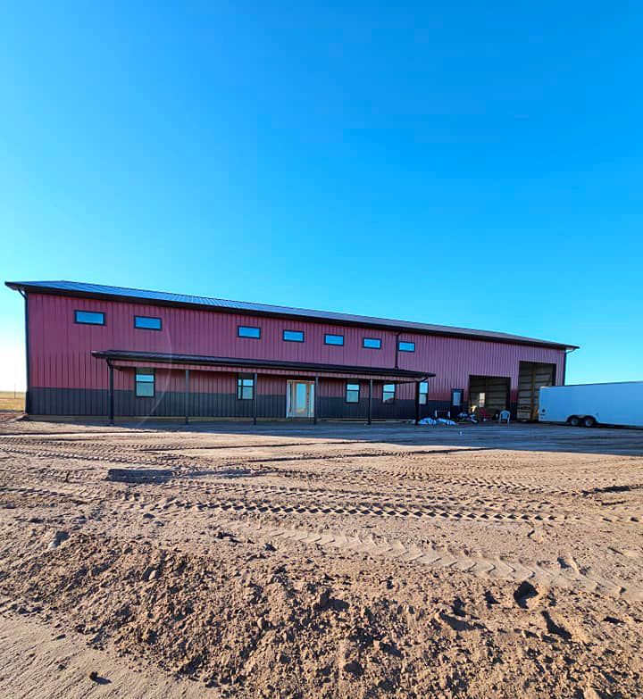 A large red building with a white truck parked in front of it