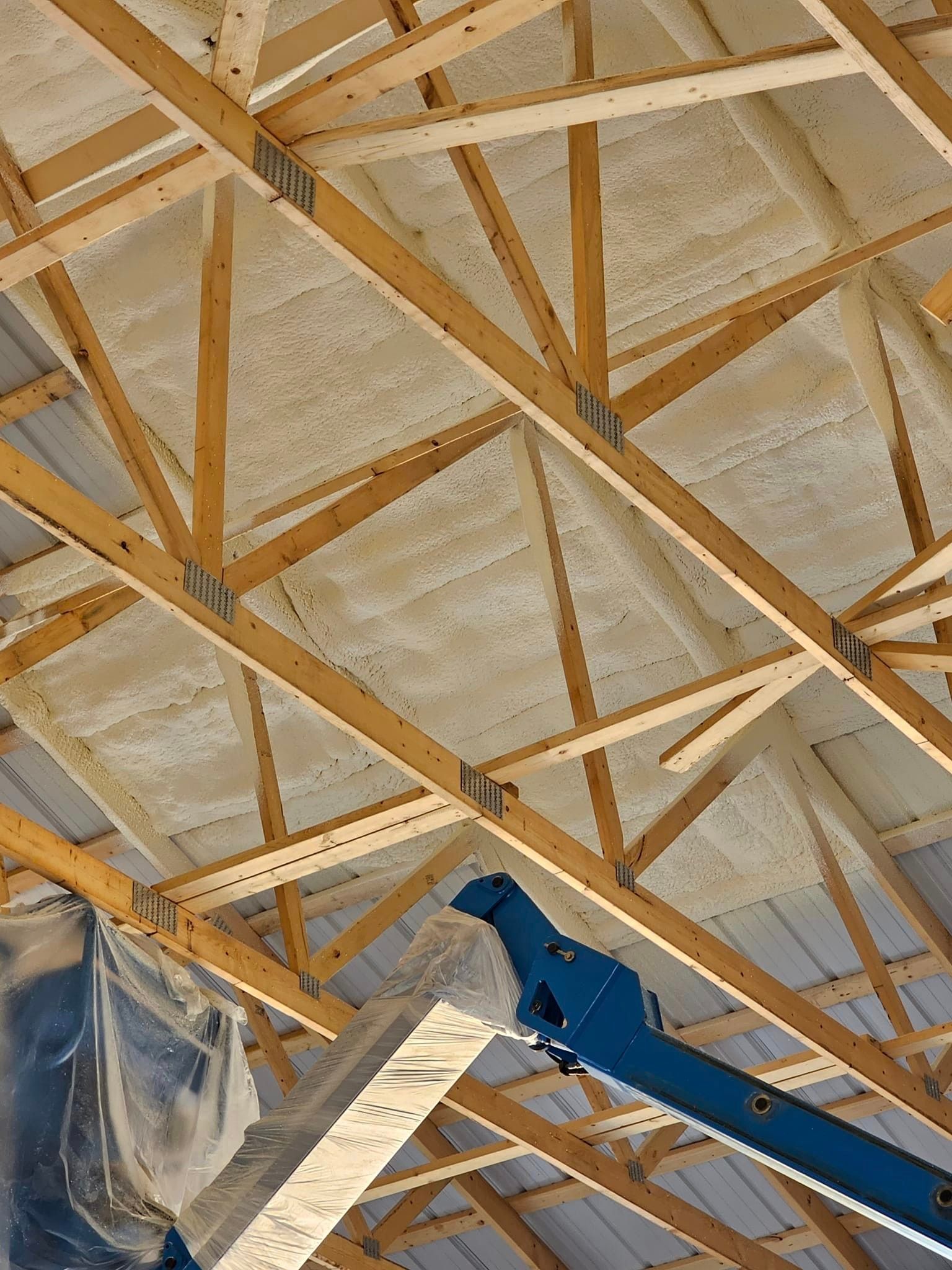 The ceiling of a building is covered in foam and wooden beams.