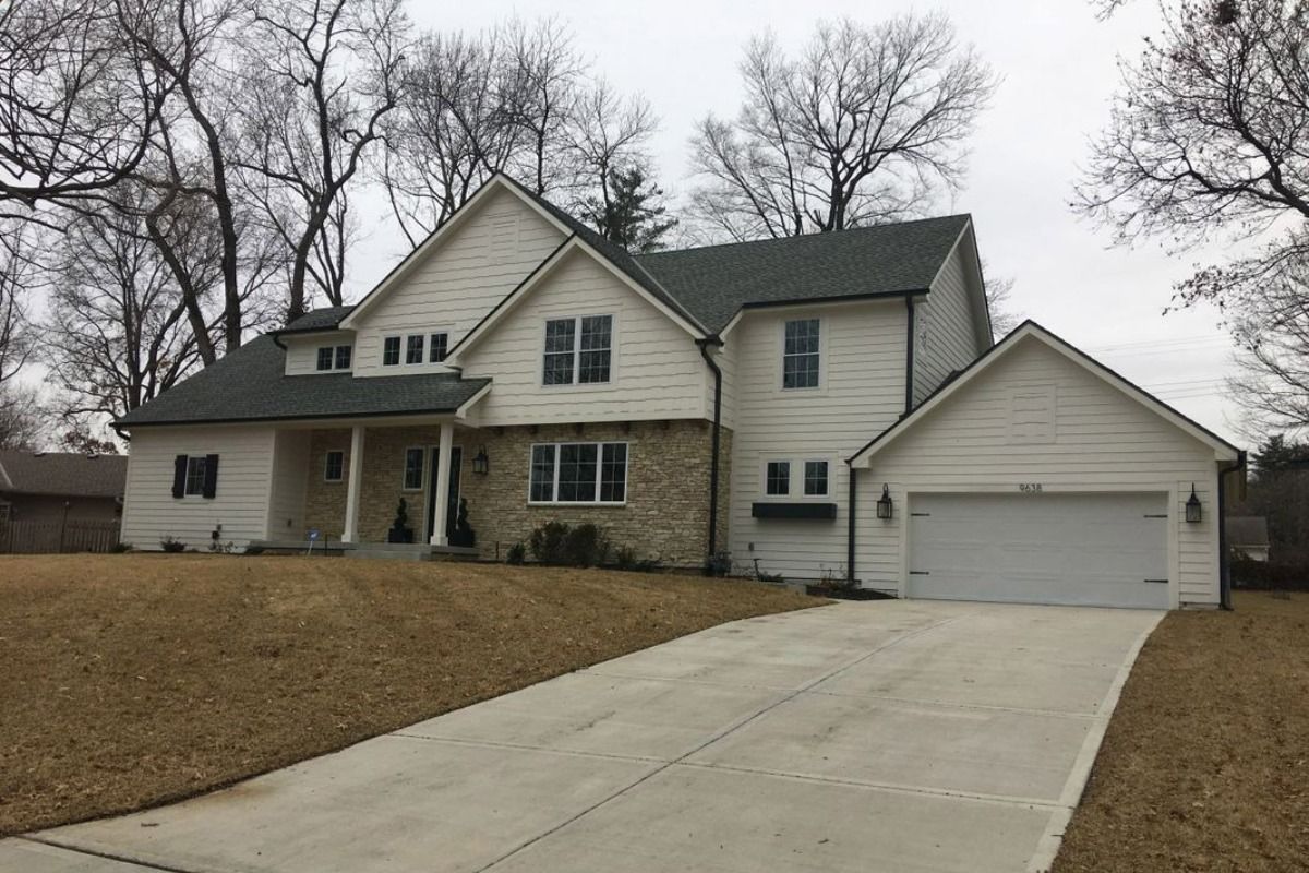 A large white house with a garage and a driveway